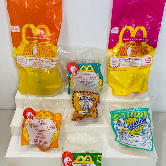 7 VNTG MCDONALDS TOYS TinyToon/Tigger/Pooh/Mickey/Dinosaurs/Phillip, Sealed Pkgs - Picture 1 of 3